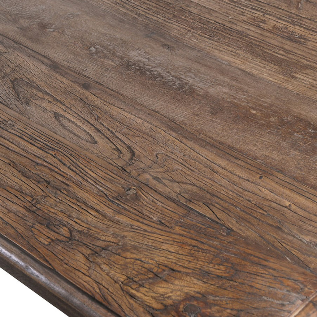 Detailed shot of the Reclaimed Elm Dining Table's reclaimed wood surface, emphasising sustainability