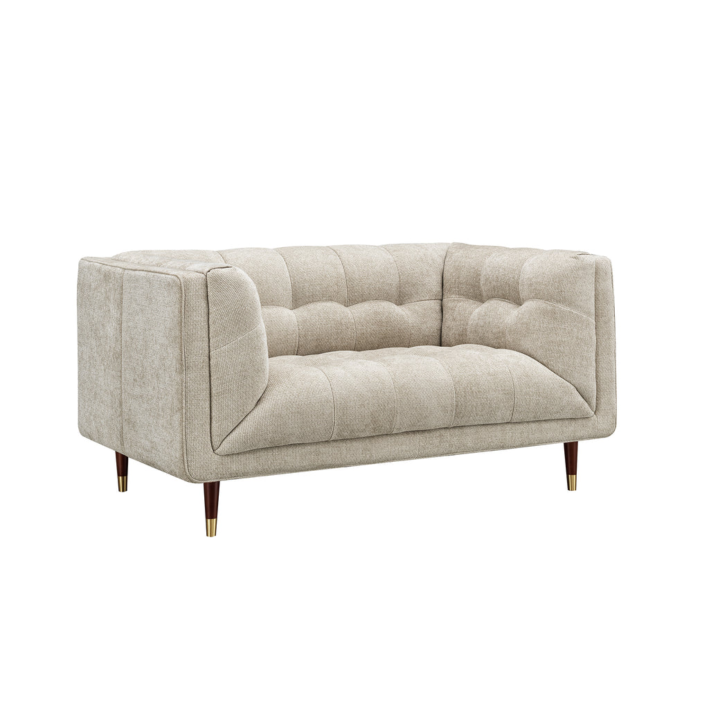 A modern two-seater loveseat sofa upholstered in a textured light beige fabric, featuring tufted button detailing on the backrest and seat, with tapered dark wood legs and gold metal tips, shown against a plain white background.
