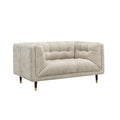 A modern two-seater loveseat sofa upholstered in a textured light beige fabric, featuring tufted button detailing on the backrest and seat, with tapered dark wood legs and gold metal tips, shown against a plain white background.