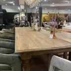 Side angle of the Reclaimed Elm Dining Table highlighting its sturdy legs and rustic finish