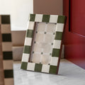 White and green 6x4 photo frame on wooden shelf