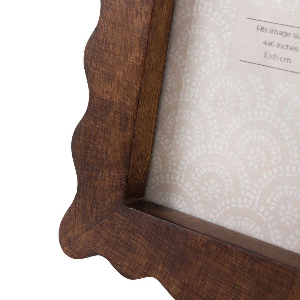 Close-up of a wooden picture frame with a textured edges