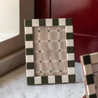 White and green 7x5 photo frame on modern shelf
