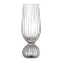 Clear champagne glass with ribbed design on a white background