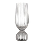 Clear champagne glass with ribbed design on a white background