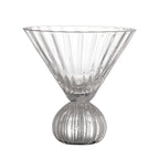 Clear glass martini glass with ribbed design on a white background