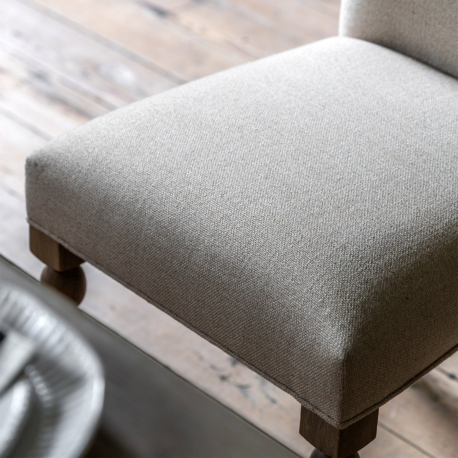 Close-up detail of Wallingford Dining Chair's seat upholstery, highlighting the texture, stitching, and quality fabric finish