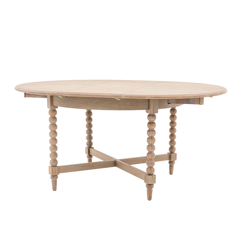 Wallingford Round Extending Dining Table fully extended to oval shape, displaying the expansion leaves and increased seating capacity for entertaining.