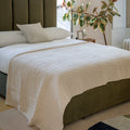 Taupe bedspread on modern bed with neutral d√©cor
