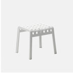 White stool with a grid pattern on a light grey background