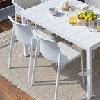 White outdoor table with Bit chairs by Nardi Outdoor on a wooden patio
