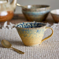 Two-tone blue and yellow cup with vibrant design for everyday use.