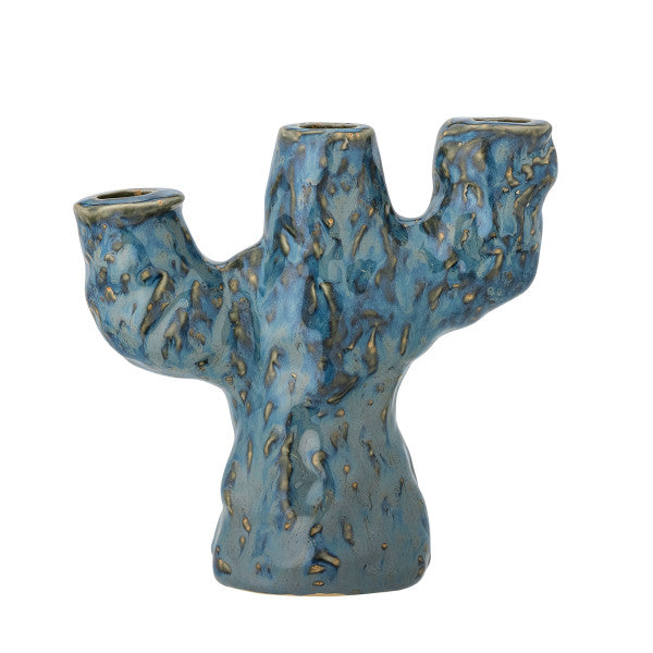 Glass blue candle holder creating soft ambient light