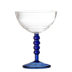Clear glass with a blue stem on a white background