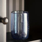 Elegant blue drinking glass on neutral background