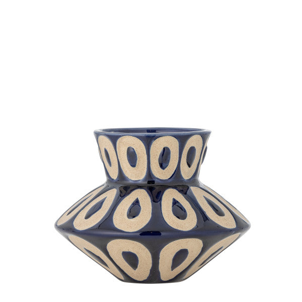 Blue ceramic vase with beige circular patterns on a white background