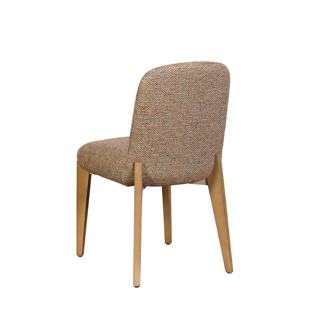 A modern dining chair with a textured, multi-colored tweed upholstery in beige, brown, and orange tones, supported by four tapered light wood legs, shown from a three-quarter angle against a plain white background.