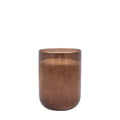 Tall large brown candle placed in living room setting
