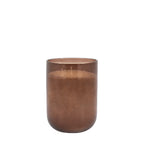 Tall large brown candle placed in living room setting