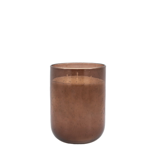 Tall large brown candle placed in living room setting