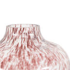 Glass vase with red and white marbled pattern on a white background