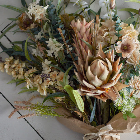 Yellow artificial flowers arranged in a vase for bright home decor