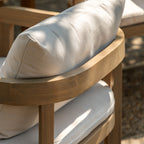 Detail view of the Cabo acacia chair in a garden setting on a sunny day