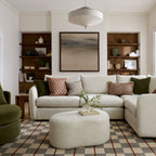 Living room with a beige Carnaby Corner Sofa & Pebble Footstool In Soft Boucle Oatmeal Fabric sofa, With Decorative Pillows.