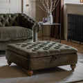 Green tufted ottoman in a living room setting with a sofa and decorative items.