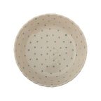 Ceramic bowl with blue polka dots on a white background