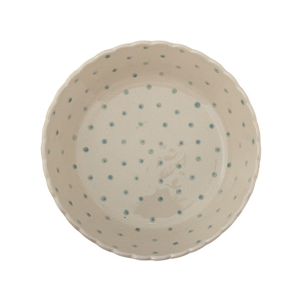 Ceramic bowl with blue polka dots on a white background