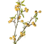 Close up of artificial plant branch with yellow flowers and green leaves on a white background