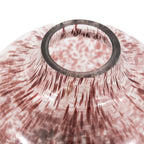 Close-up of a pink and white patterned vase with a metallic ring