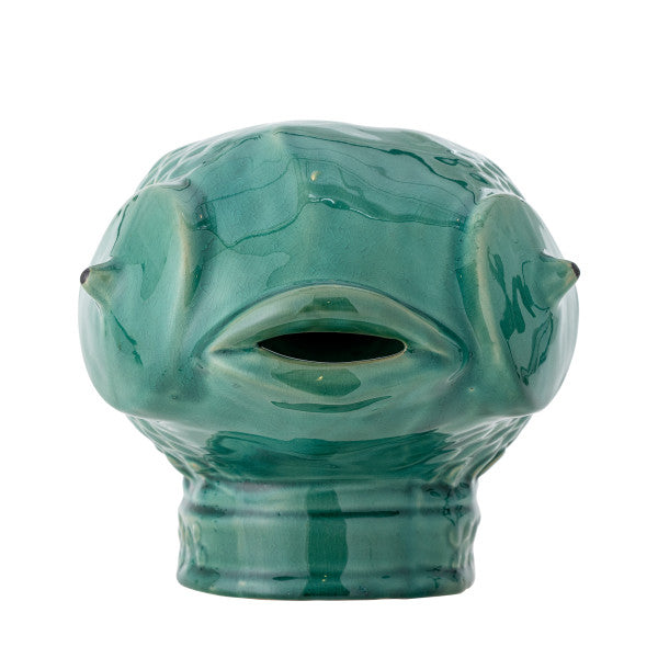 Green ceramic vase with textured surface and eye-like design on a white background