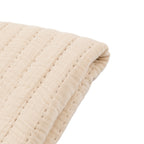 Cosy taupe bedspread layered with bedding