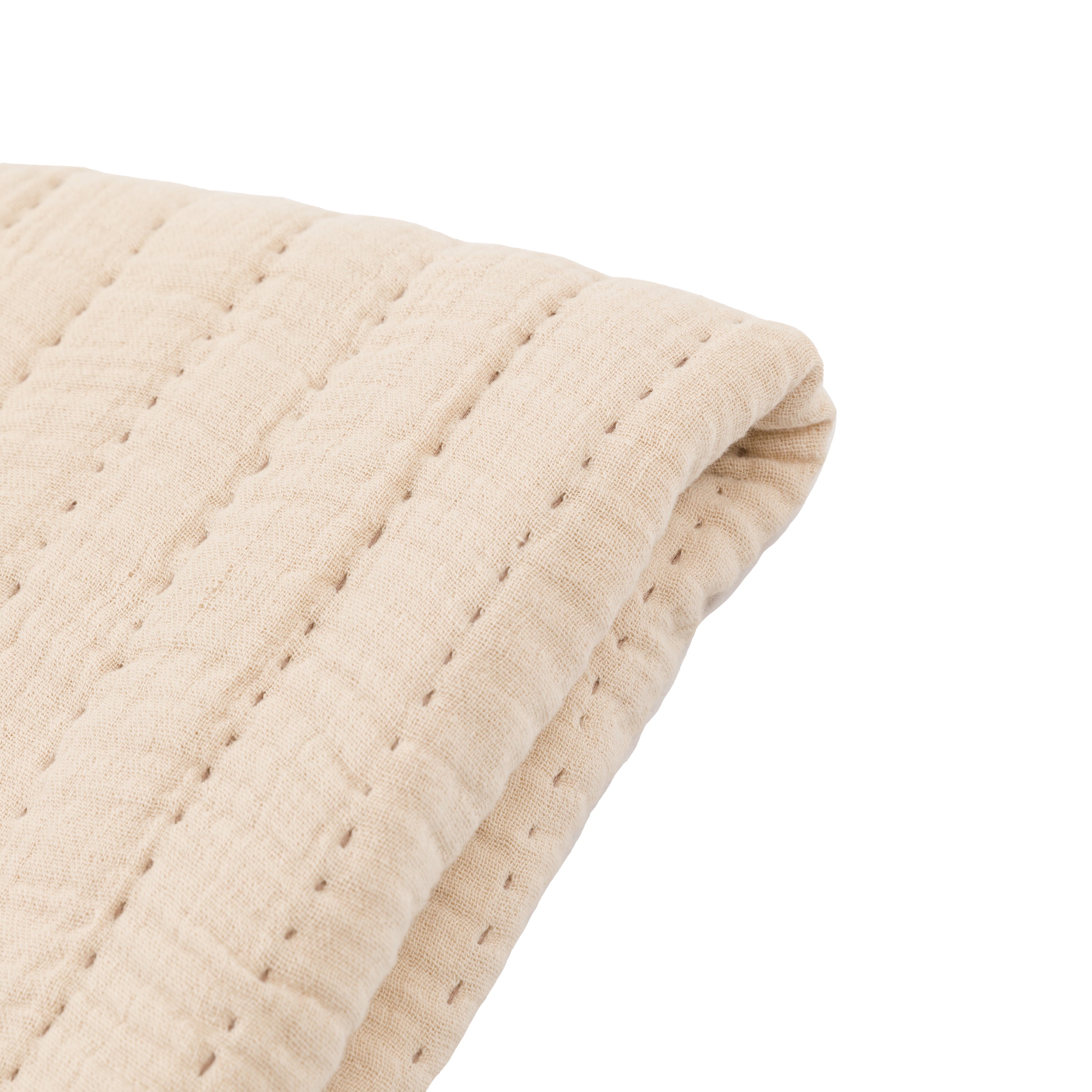 Cosy taupe bedspread layered with bedding