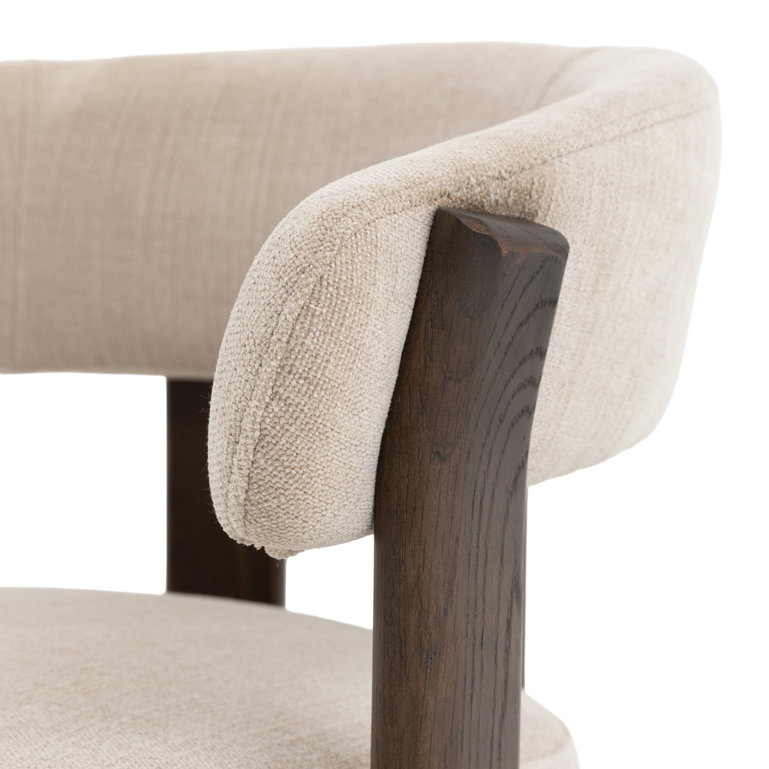 Close-up of a chair with natural cushioned backrest and wooden armrest