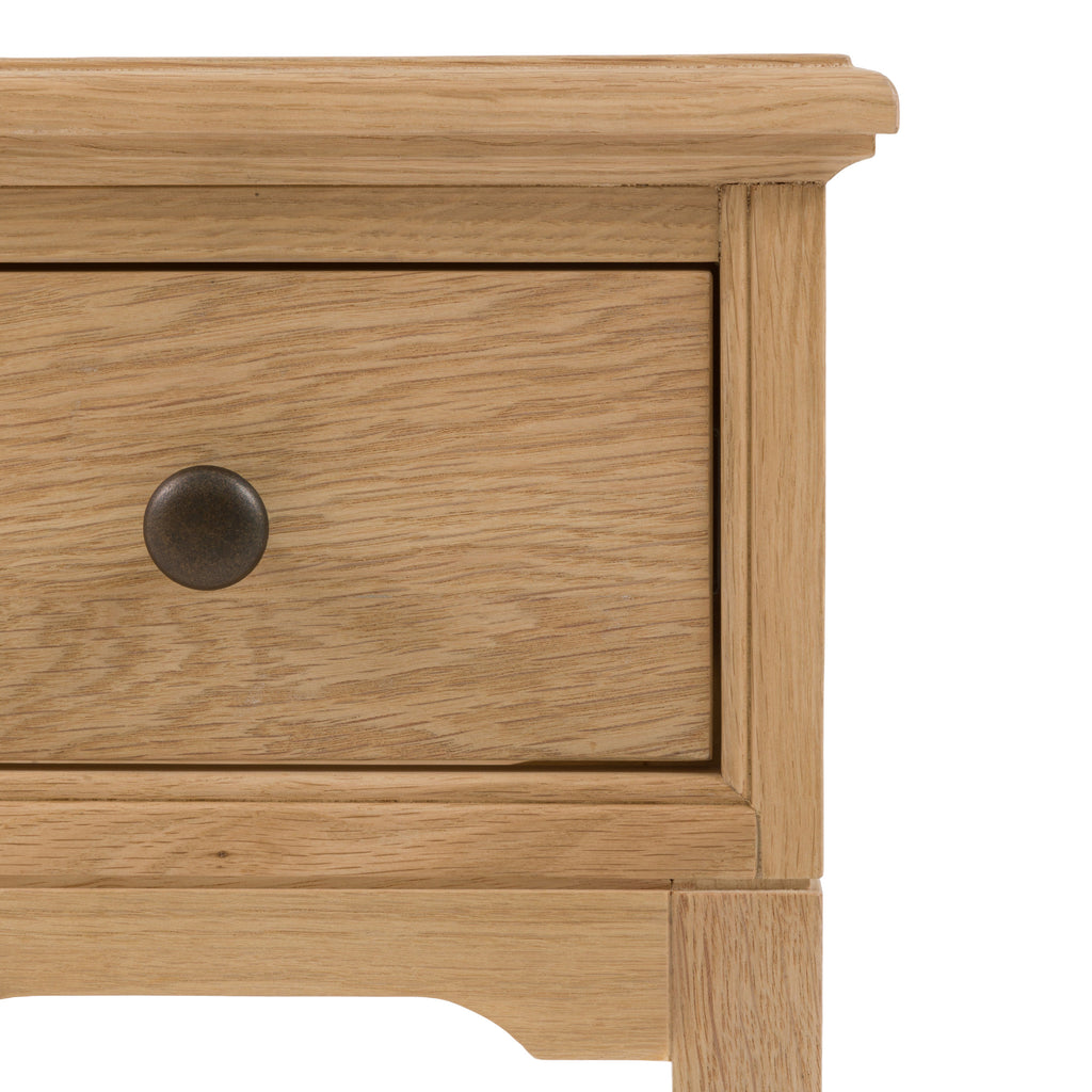 Detailed photo of an oak drawer with a knob on a white background, from a 1 drawer bed side table.