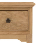 Detailed photo of an oak drawer with a knob on a white background, from a 1 drawer bed side table.