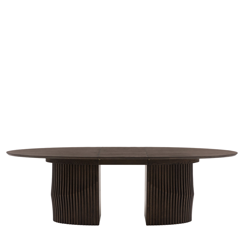 Oval dining table extended with guests seating arrangement
