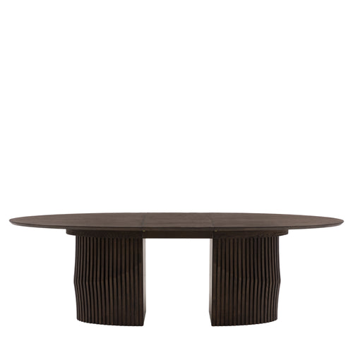 Oval dining table extended with guests seating arrangement