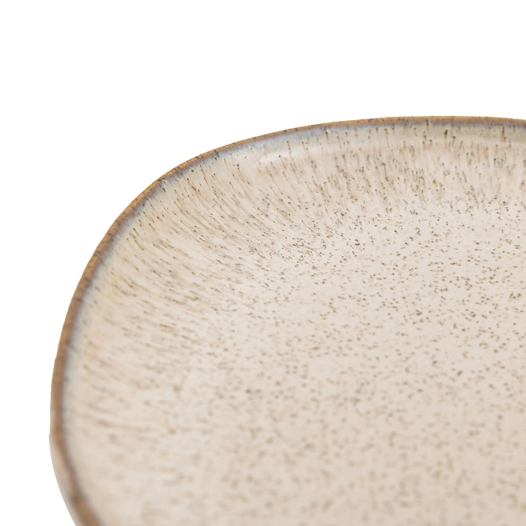 Minimalist white side plate styled with breakfast oats and fruit