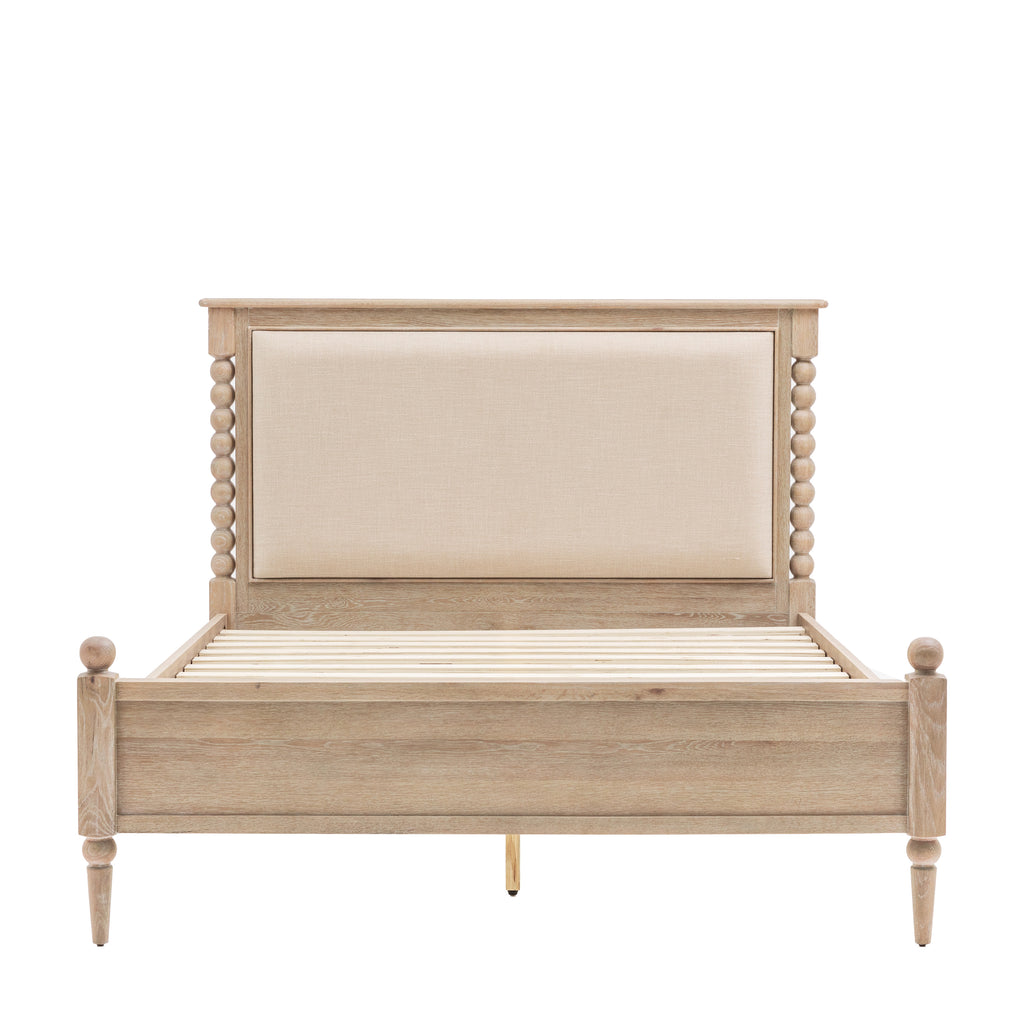 Wooden bed with upholstered headboard on a white background