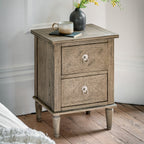 Faringdon 2 Drawer Bedside Table in a styled bedroom setting next to a bed, demonstrating its functionality for night-time essentials and decorative items