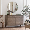 Faringdon 7 Drawer Chest in a styled bedroom setting, demonstrating its functionality as both storage and a display surface for personal items.