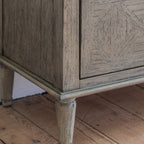 Side angle of Faringdon 7 Drawer Chest showcasing its height, proportions, and the detailed craftsmanship of the turned feet and frame.