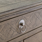 Detail view of Faringdon Chest's drawer hardware, showing the brass handles that complement the natural wood finish and add a touch of elegance