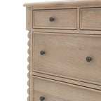 Wooden dresser with four drawers and metal knobs on a white background