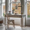 Faringdon Desk in a styled home office setting with chair, showing its proportions and how it fits in a workspace environment.