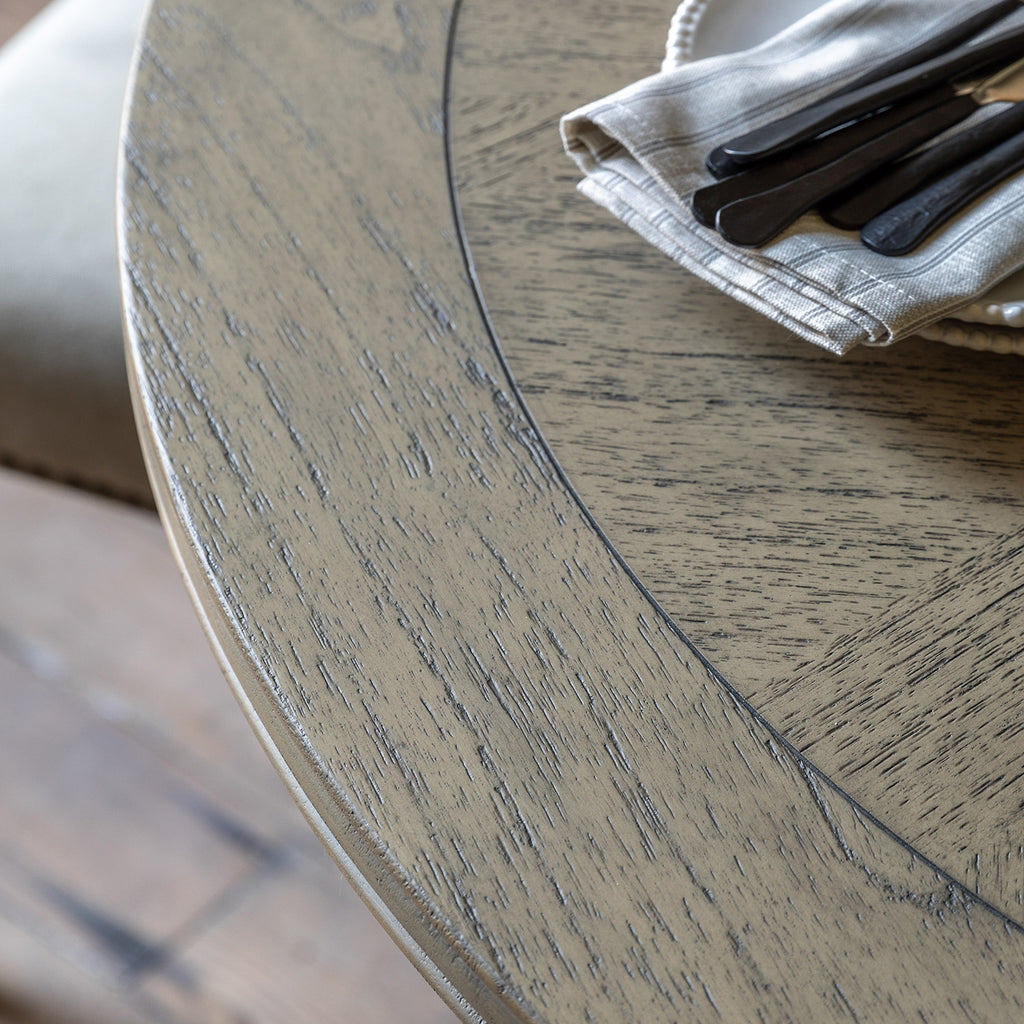 Close-up detail of Faringdon Round Dining Table's inlaid parquet wood pattern, highlighting the natural grain and artisanal craftsmanship